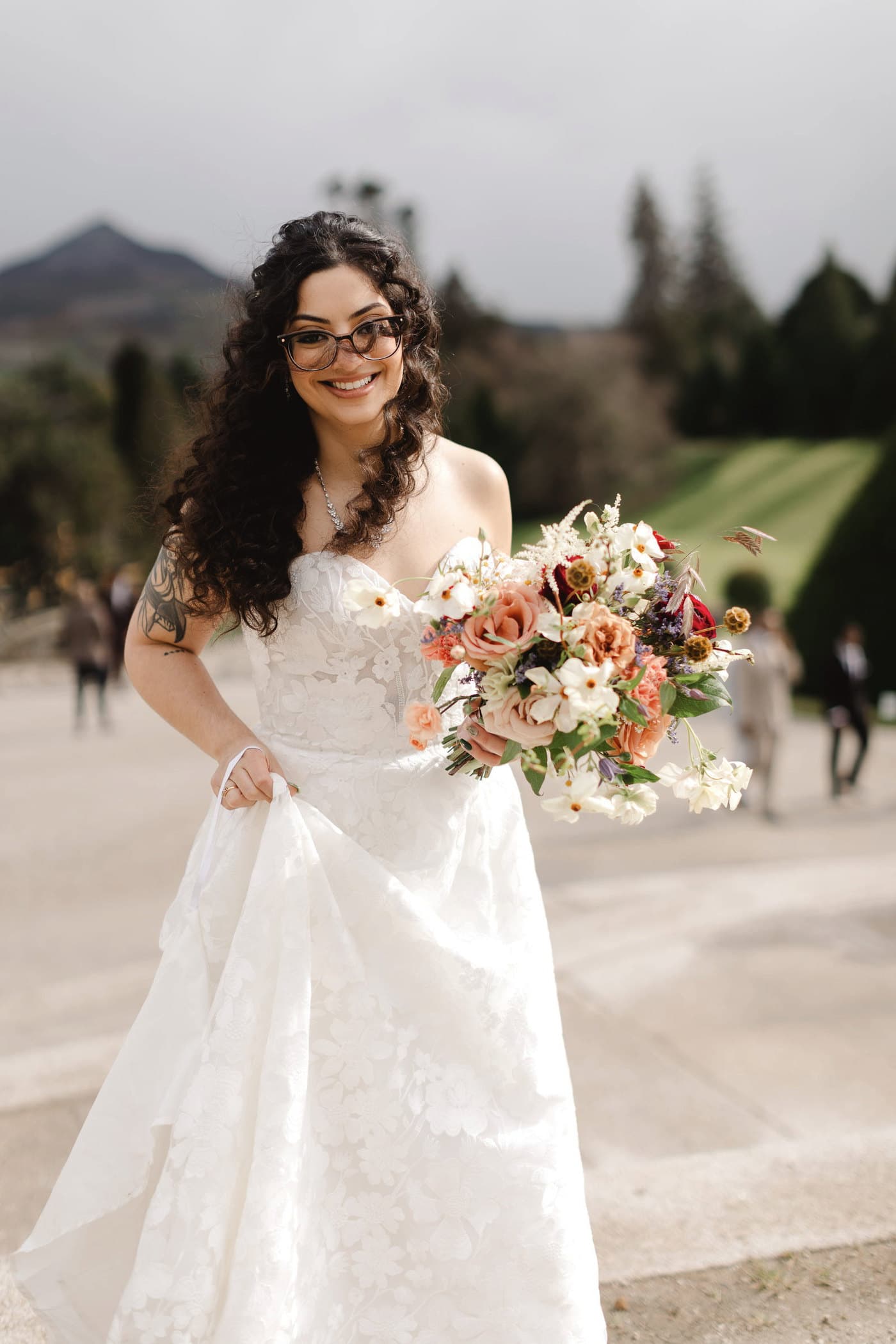 Bride on an Irish hillside, mountains behind her.